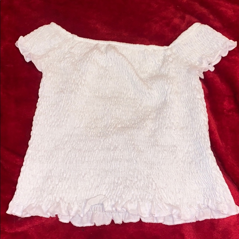 white ruffled of the shoulder top